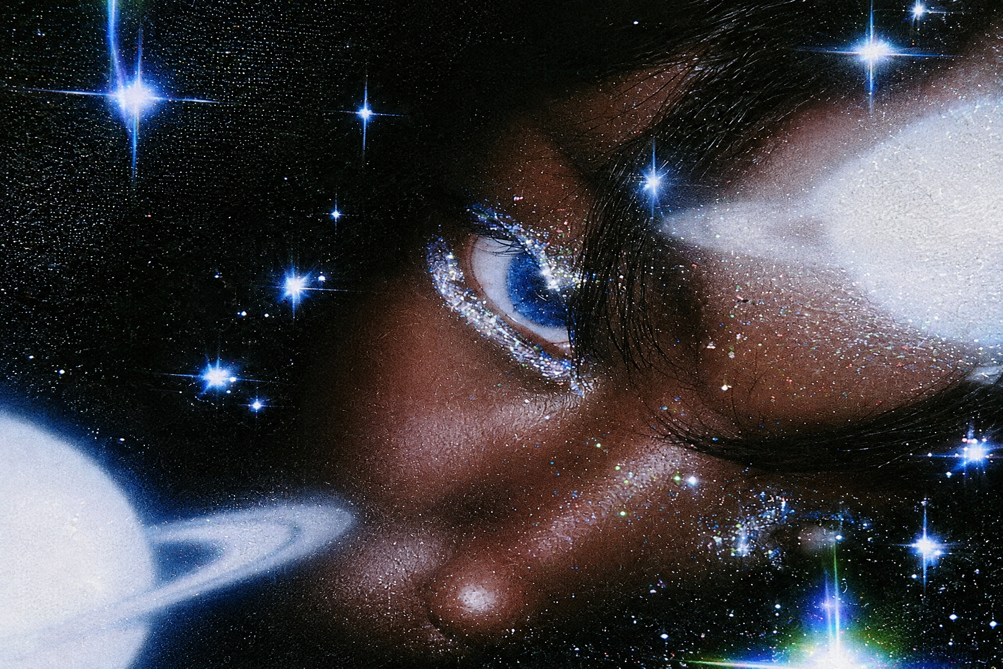 A blue eye and glittered face layered with bright stars and a cosmic landscape.